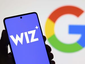 The Wiz logo on a smartphone and the Google logo behind