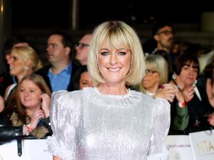 Jane Moore smiling in a white top