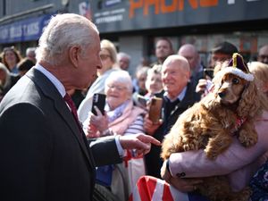 Charles speaks to a lady holding a cute cocker spaniel dog