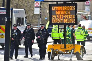 Armed police keep watch on the surrounding streets