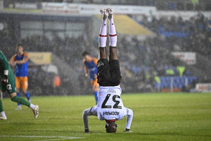 Walsall attacker Albert Adomah pulls out the handstand celebrations after scoring his 100th club career goal. (Image by Owen Russell)