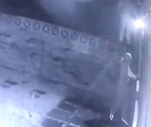 One of the thieves at the back door to the house