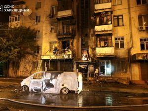 Emergency services personnel work to extinguish a fire following a Russian attack in Kharkiv