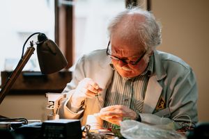 Volunteer repairer Chris Byard gets to work fixing a portrait speaker