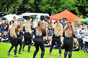A dance group routine keeps the crowd entertained