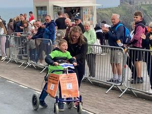 Supporting image for story: Boy, eight, with rare disease completes Ironkids Wales with walker