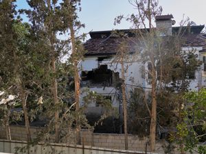 The impact of a projectile is visible on the wall of a UN guesthouse where United Nations workers were located when the building was struck, leaving one staff member dead and five others injured, in Deir al-Balah, central Gaza