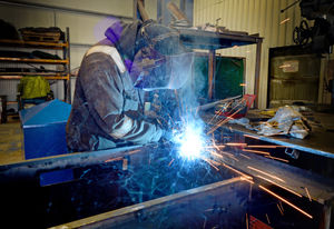 Fabrications manager Mick Ufton welds one of the bins, with 19 currently out in the community