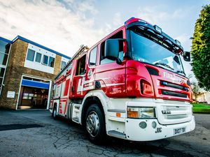 Supporting image for story: Firefighters free dog after it had become trapped inside its cage
