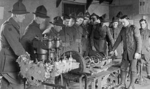 Second lieutenant Randolph Ridling, behind the table with arm extended, giving instruction at Brocton