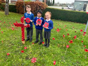 Children from Landywood Primary School [L-R] Rowan Perry, 9, Dev Chamdal 7, Lola Barton 6 stand in a sea of Poppies at Waters Edge Care Home