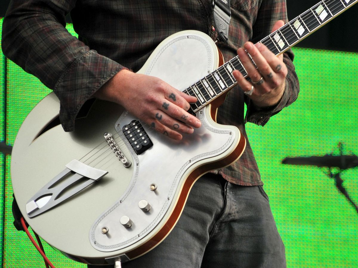 Queens Of The Stone Age headline festival rocked by controversy