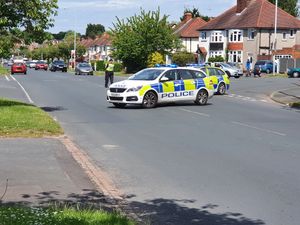 The scene in Oxbarn Avenue, Bradmore, Wolverhampton, after a delivery driver was run over while trying to stop his van from being stolen