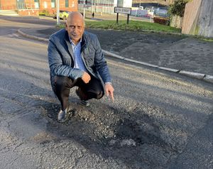 Cllr Shaukat Ali shows off a pothole in Bath Street Dudley. Picture Cllr Shaukat Ali free for LDR use