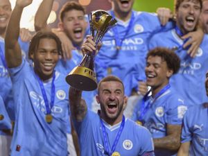 Manchester City’s Kyle Walker lifts the FIFA Club World Cup trophy