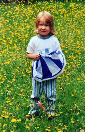 Two years old – little Ella in a field of flowers