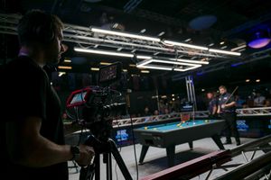 A cameraman films Ultimate Pool