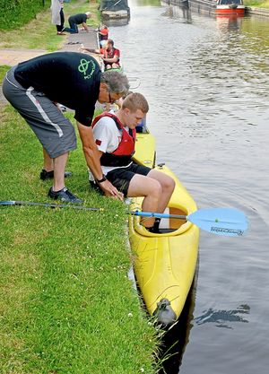 Express & Star reporter Jamie Brassington is shown how to get into a canoe correctly by Bankside coach Nigel Hargrave at Gailey Canoeing Club, Croft Lane, Gailey, Penkridge.