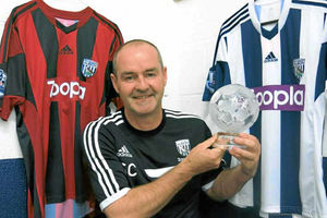 Steve Clarke shows off the Performance Of The Week award following the victory at Manchester United