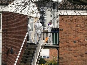 Police forensic teams at Miss Jones' flat