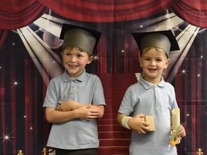Supporting image for story: Little students look the part for their first 'graduation' at village primary school
