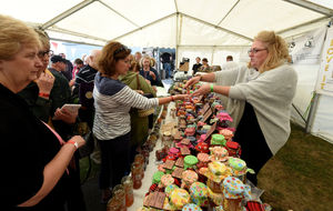 Heather Williams from Heather's Harvest of Shrewsbury serves a customer