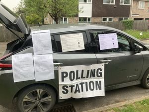 Supporting image for story: Voters cast ballots from back of car as usual polling station was shut