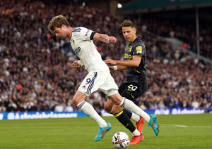 Leeds United's Patrick Bamford and Aston Villa's Jan Bednarek battle for the ball 