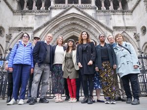 Group of people standing together in front of the high court building in London