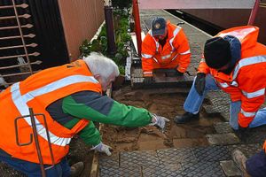 Volunteers relaying paving as part of the platform development