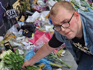 Ian Stone, from Birmingham, placed flowers on the ever growing mountain of tributes