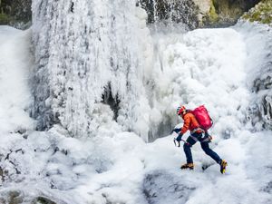 Supporting image for story: Man scales frozen waterfall in national park amid ‘very rare’ conditions