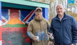 Artist Neil Wallis and Council Leader Lee Carter after it was vandalised last month