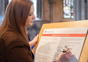 Michelle Hayes, Internal Communications and Events Manager, TopCashback signing the COP Charter