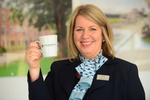 BG - A David Wilson Homes Sales Adviser holding a mug of tea