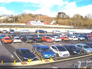 Car park at Derriford Hospital with helicopter in background