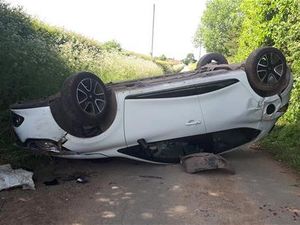 Supporting image for story: Stolen car found abandoned on roof blocking country lane
