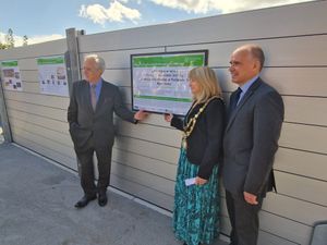 Mark Garnier, Nicole Harper and Anthony Perry pose next to the plaque on the new barriers