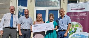  Katie Jones from Mid and North Powys Mind (second from right) receives a cheque from Rees Astley staff (from left) Chris Tombleson, Alun Hughes, Jackie Rollo and Steve Owen.