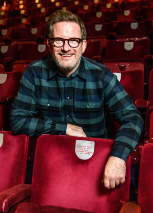 Matthew Bourne with his seat plaque at Birmingham Hippodrome