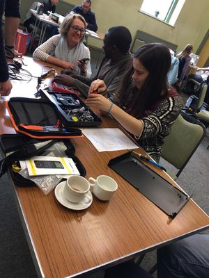 The repair of an electrical item at a repair cafe.