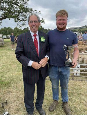 Nathan Price receiving the Lydia Lewis Memorial cup from president Martin Udall