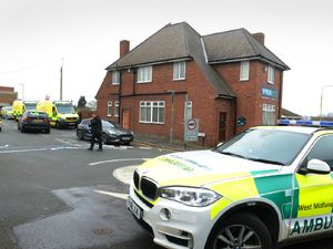 Supporting image for story: Police help man down from factory roof in Dudley as road closed
