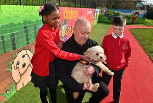 Headteacher Richard Thorpe with his and the school's dog Freddie and pupils Hadassah, 11 and Toby, 10