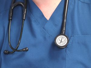 A doctor holding a stethoscope