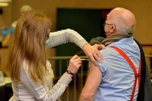Advanced nurse practitioner Karen Aucock giving the vaccine to Peter Bevan, 83