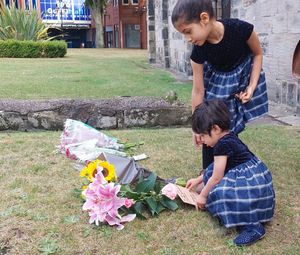 Ayreen Kalathingal aged six and Alizay Kalathingal aged two, laying flowers in Stafford