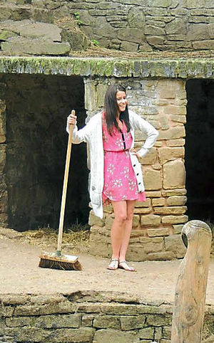 Jessica Holliday, left, busy mucking out