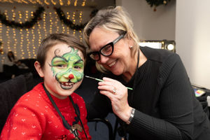 David Craciun has his face painted by Deb Moss