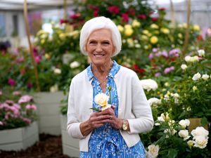 Dame Mary Berry holds the Mary Berry Rose during the RHS Chelsea Flower Show press day at the Royal Hospital Chelsea, London, in 2022